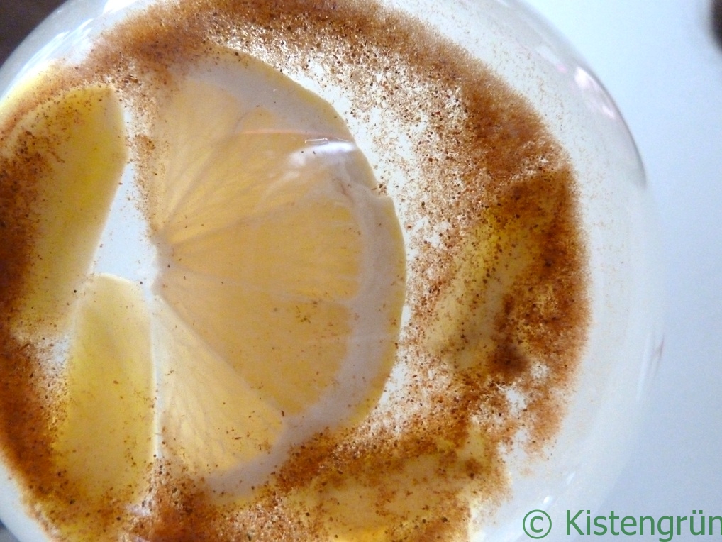 Frischer Ingwertee mit Zitrone und Zimt in einem Glas