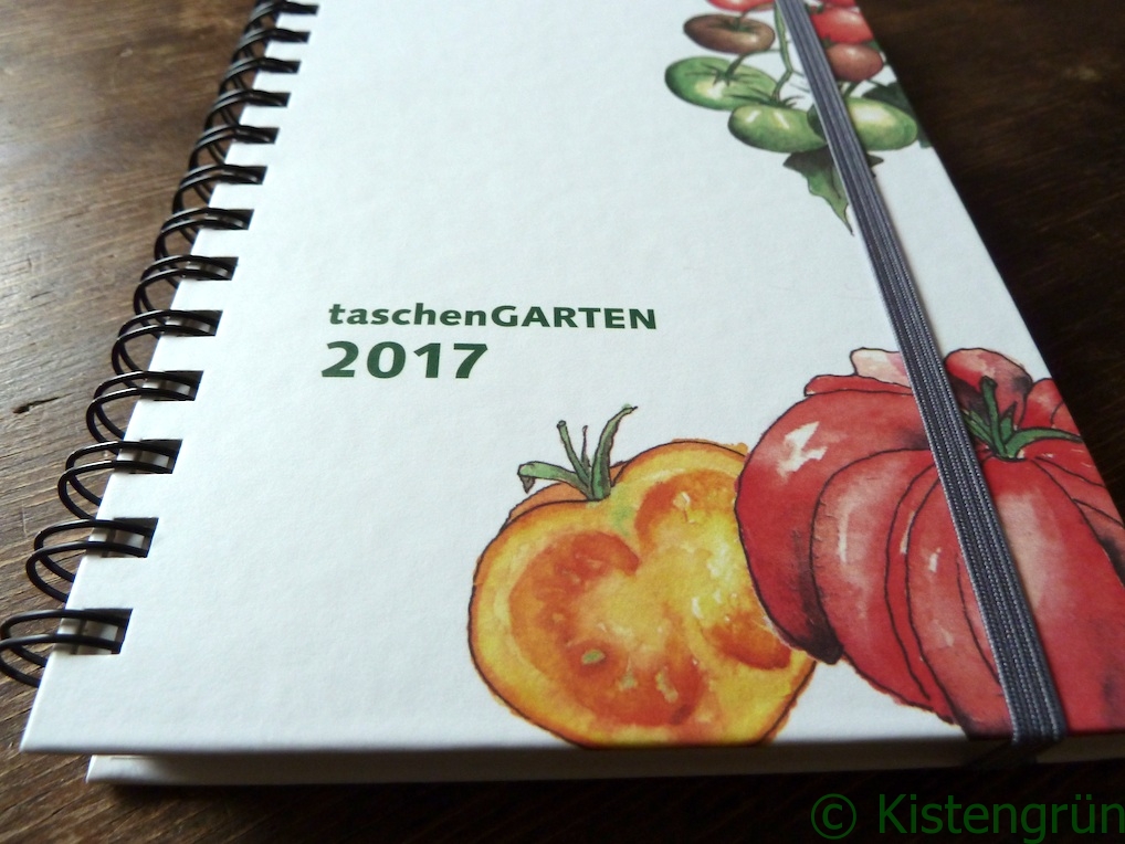 Gartenkalender Taschengarten auf einem braunen Holztisch